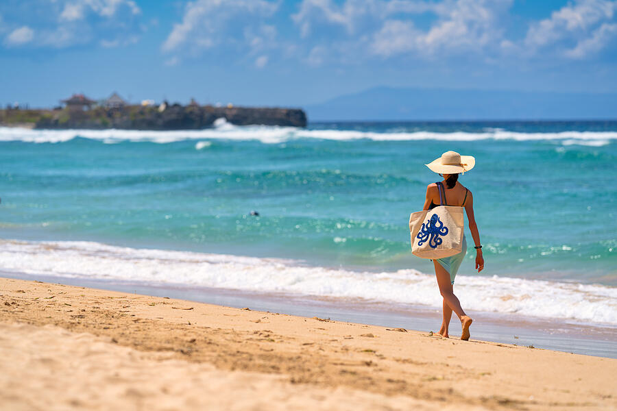 A woman walking nearby to the sea with a beautiful bag, Nusa Dua Beach, Bali, Indonesia Photograph by Mauro Tandoi