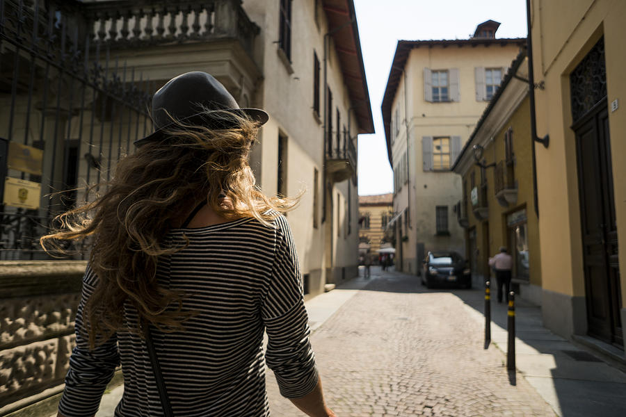 A woman walking the streets of Italy Photograph by Jordan Siemens