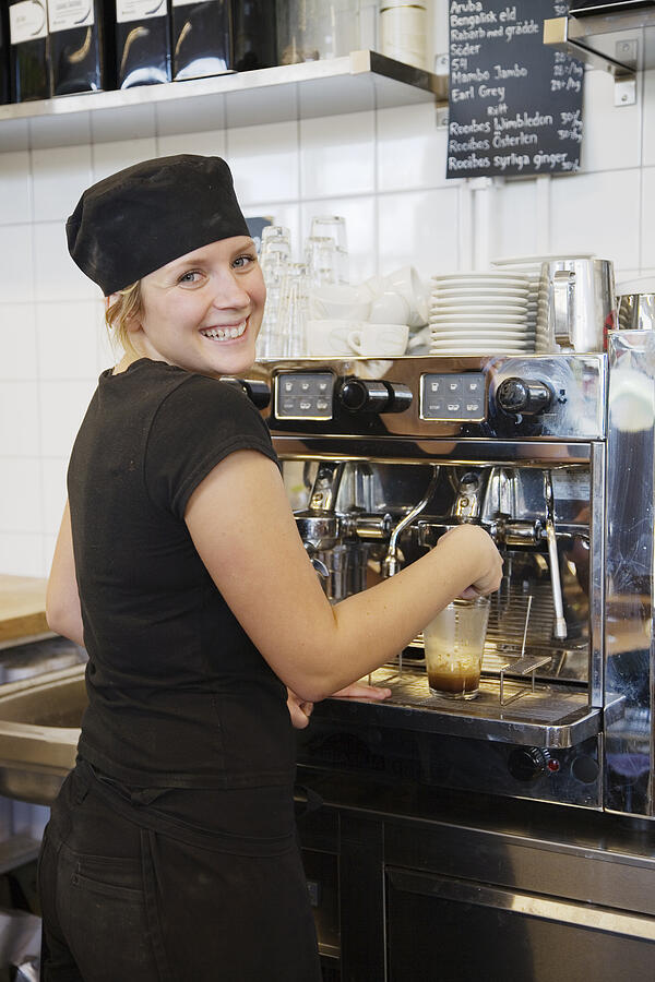 A woman working in a cafe Sweden. Photograph by AMe Photo