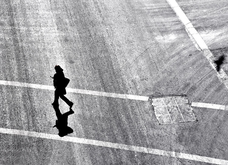 A women walking across a street using cell phone Photograph by Phil Sharp
