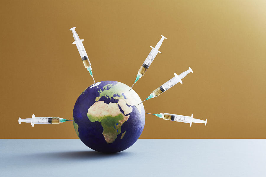 A world globe being vaccinated Photograph by Richard Drury