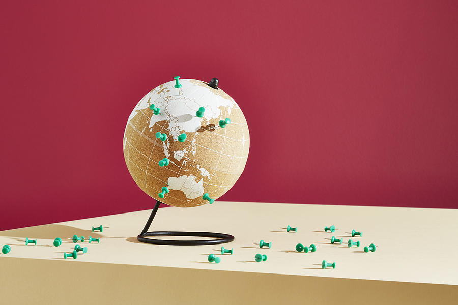 A world globe marked with push pins Photograph by Richard Drury