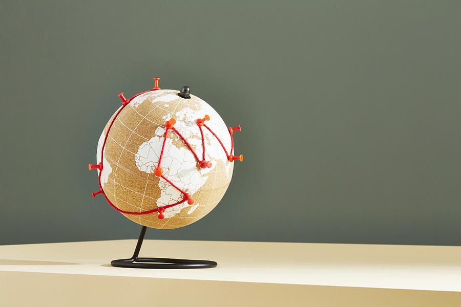 A world globe with a journey marked in red string and pins Photograph by Richard Drury