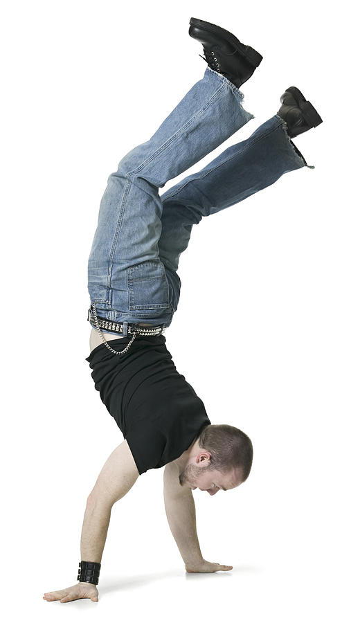 A Young Adult Male In Jeans And A Black Shirt Does A Hand Stand And Walks On His Hands Photograph by Photodisc