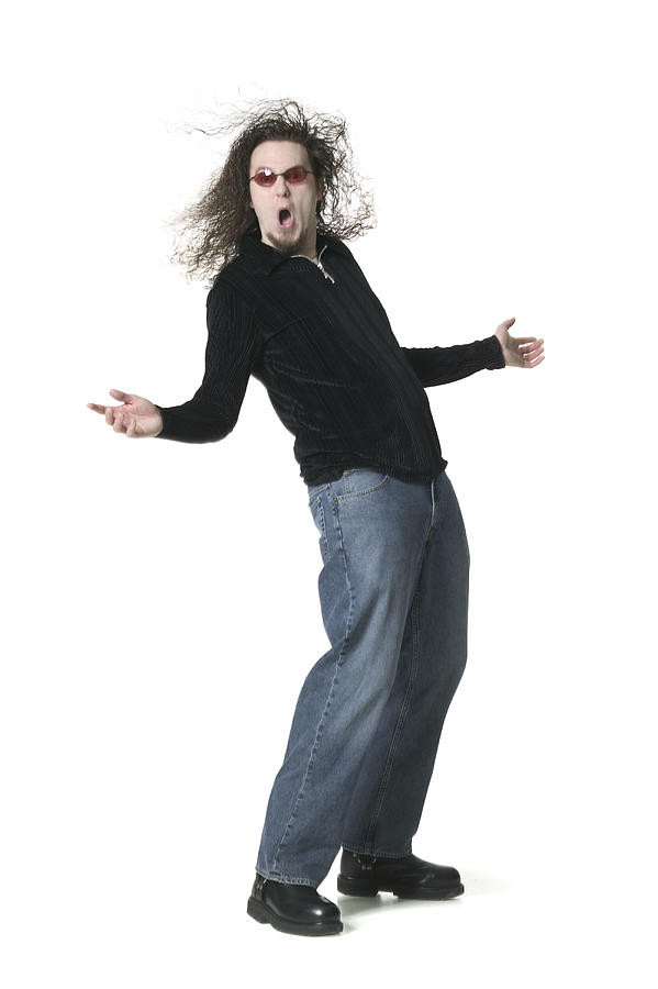 A Young Adult Male In Jeans And A Black Shirt Leans Back And Spreads Out His Arms Photograph by Photodisc
