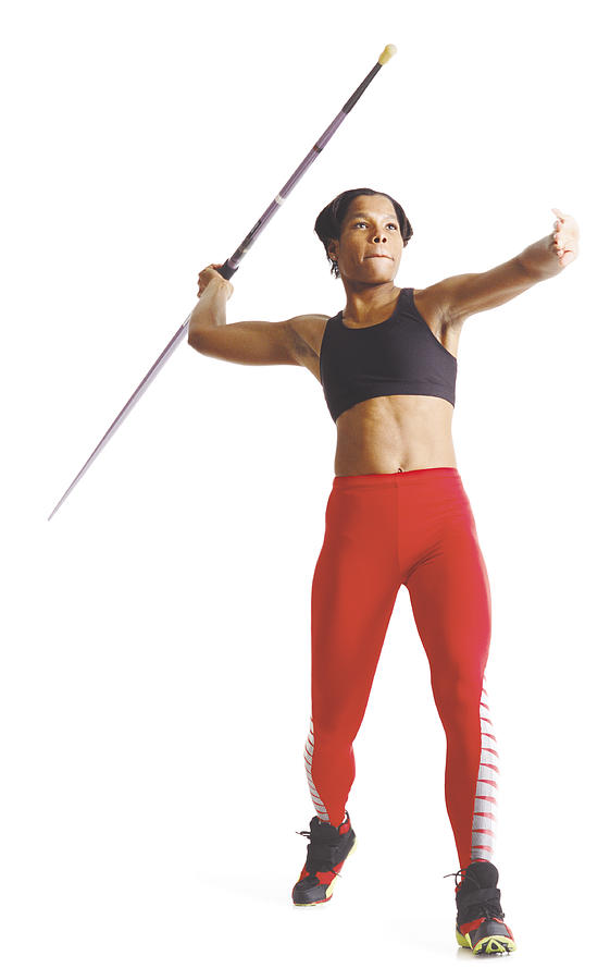 A Young African American Female Athlete In Red Pants And A Black Sports Bra Pulls Her Arm Back To Release A Javelin Photograph by Photodisc