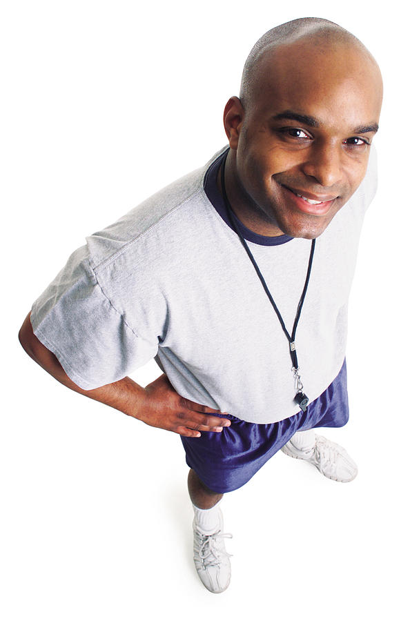 A Young African American Male Coach In Gym Clothes Smiles As He Looks Up At The Camera Photograph by Photodisc