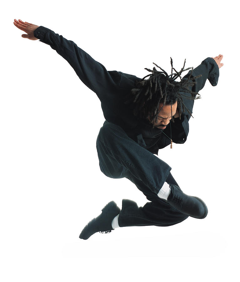 A Young African American Male Modern Dancer In Black Pants And Shirt Leaps Up And Flies Through The Air While Outstretching His Arms Photograph by Photodisc
