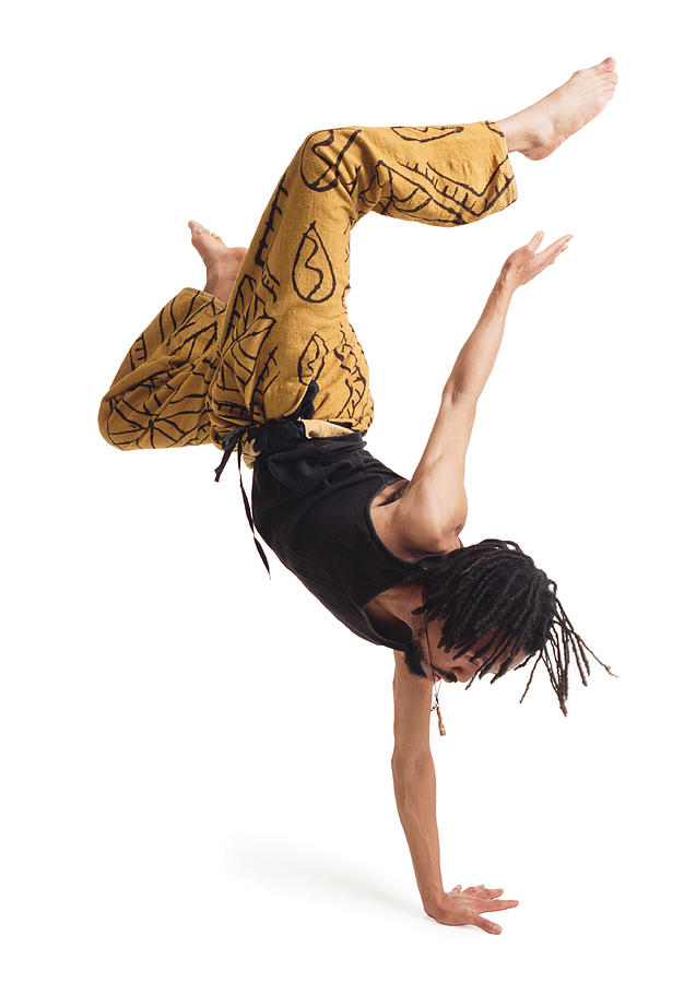 A Young African American Male Modern Dancer In Yellow Pants And A Black Tank Top Flips Himself Upside Down With One Arm And Carefully Balances Photograph by Photodisc