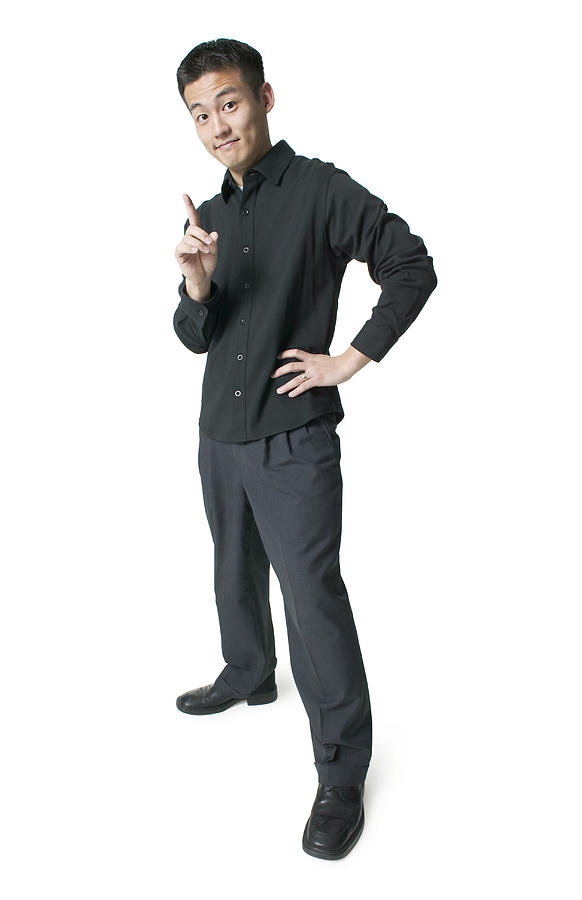 A Young Asian Man Dressed In Black Shakes His Finger And Smirks At The Camera Photograph by Photodisc