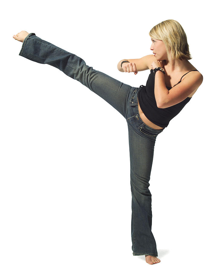 A Young Caucasian Blonde Woman In Jeans And A Black Tank Top Strikes A Martial Arts Pose Photograph by Photodisc