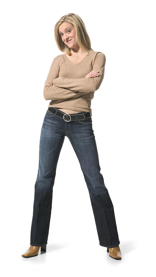 A Young Caucasian Blonde Woman In Jeans And A Tan Shirt Folds Her Arms And Smilies Photograph by Photodisc