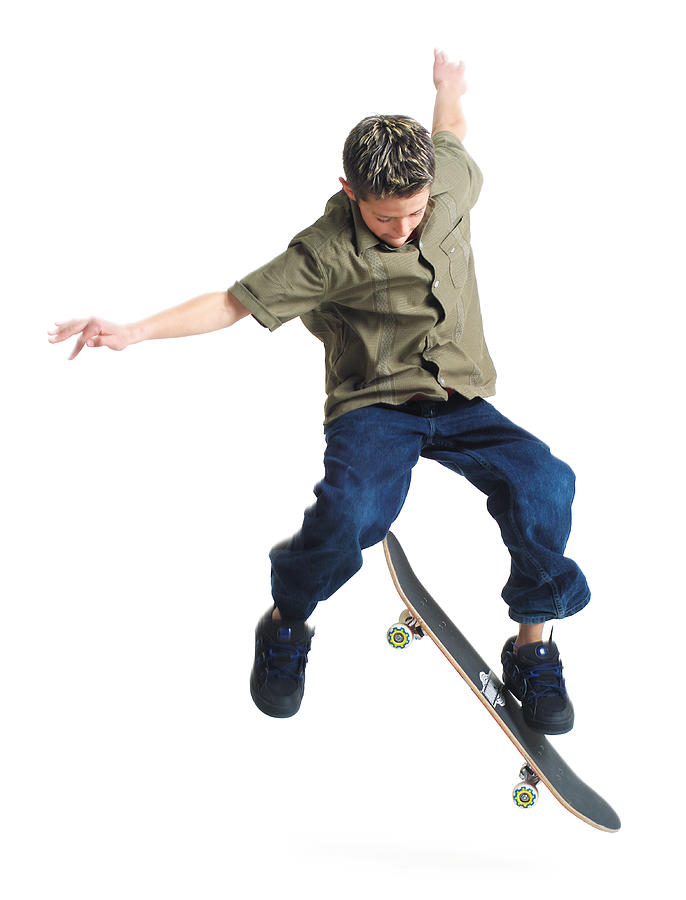 A Young Caucasian Boy Does Tricks On His Skateboard Photograph by Photodisc