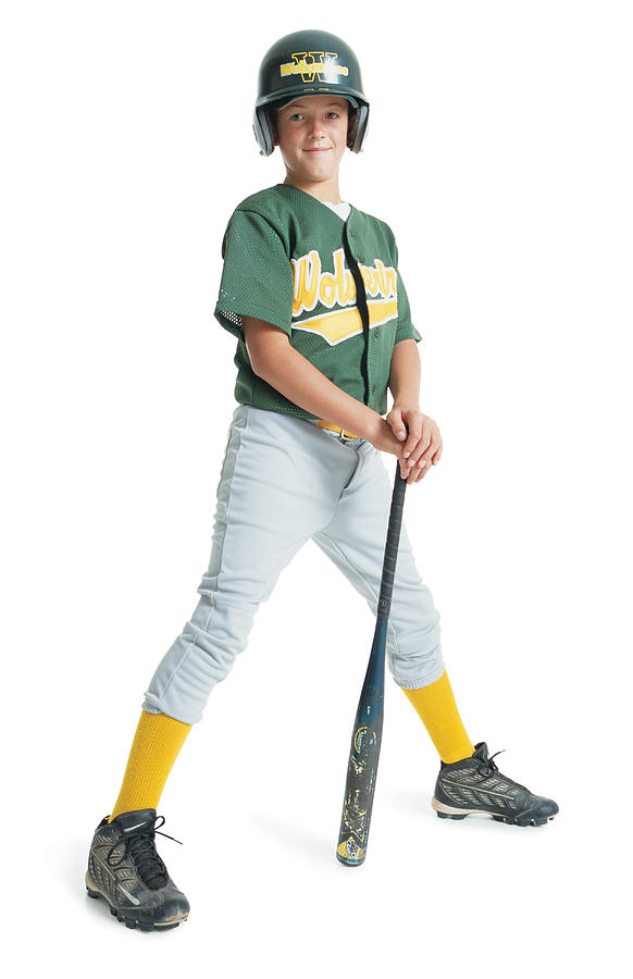 A Young Caucasian Boy Is Wearing A Green Little League Uniform And Stands Leaning On A Bat While Wearing A Green Batting Helmet Photograph by Photodisc