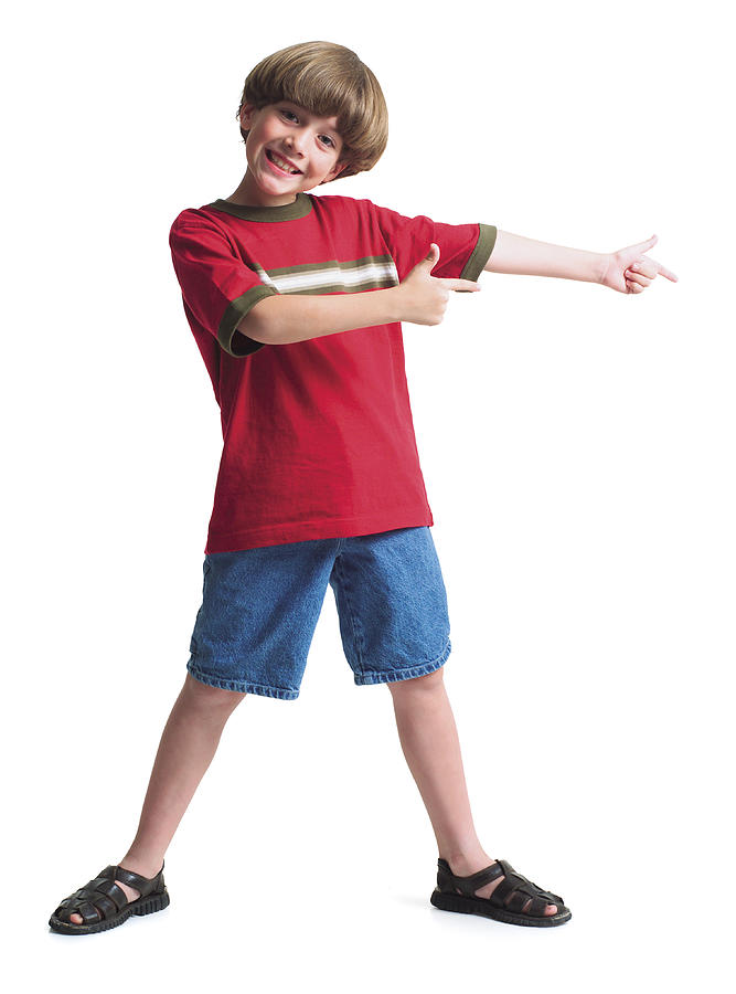 A Young Caucasian Boy Wearing Jean Shorts And A Red Shirt Stands With His Legs Spread Shoulder Width Apart And Holds His Arms Out To One Side Indicating A Product Photograph by Photodisc