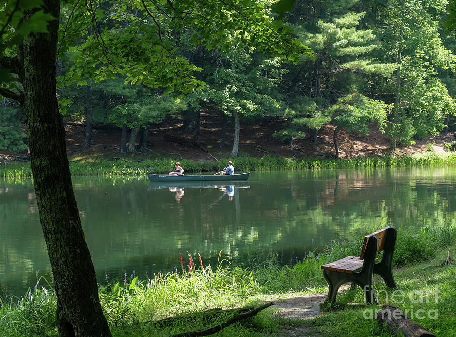 A young couple fishes from a canoe on Watoga Lake in Watoga Stat Photograph by William Kuta
