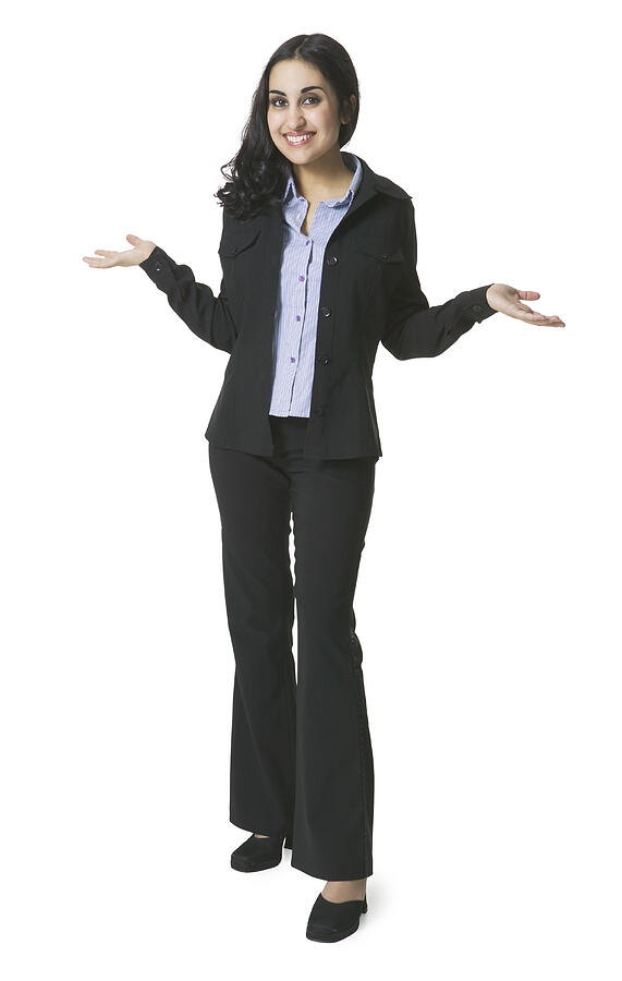 A Young Hispanic Woman In A Black Suit With A Blue Blouse Shrugs Her Shoulders And Gestures With Her Hands Photograph by Photodisc