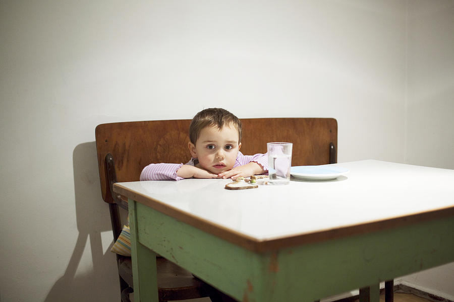A Young Kid Sits At A Table With Here Food Photograph by Frank Rothe