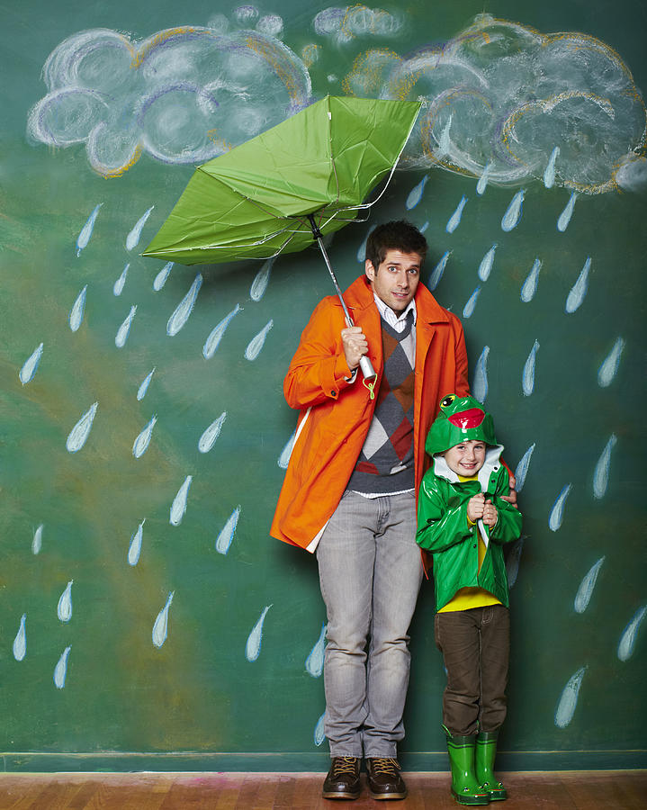 A young man and boy huddling from the rain. Photograph by Robert Deutschman