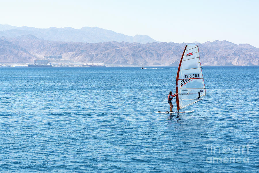 A young woman sailboards in the Gulf of Aqaba off the resort cit Photograph by William Kuta