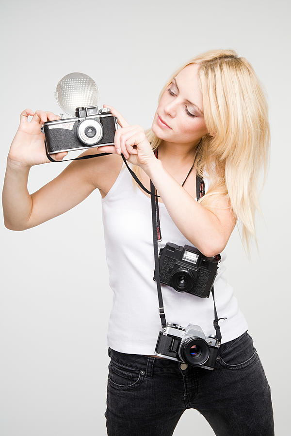 A young woman taking pictures Photograph by Image Source