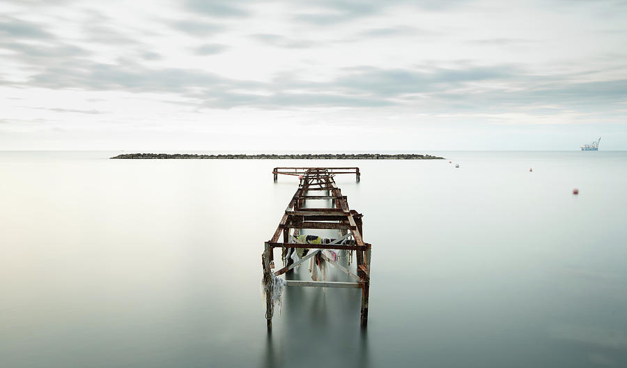 Abandoned Pier In The Ocean. Long Exposure Photograph