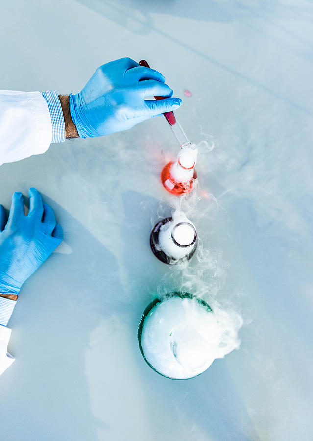 Above view of mixing poisonous chemical liquids in laboratory. Photograph by Skynesher