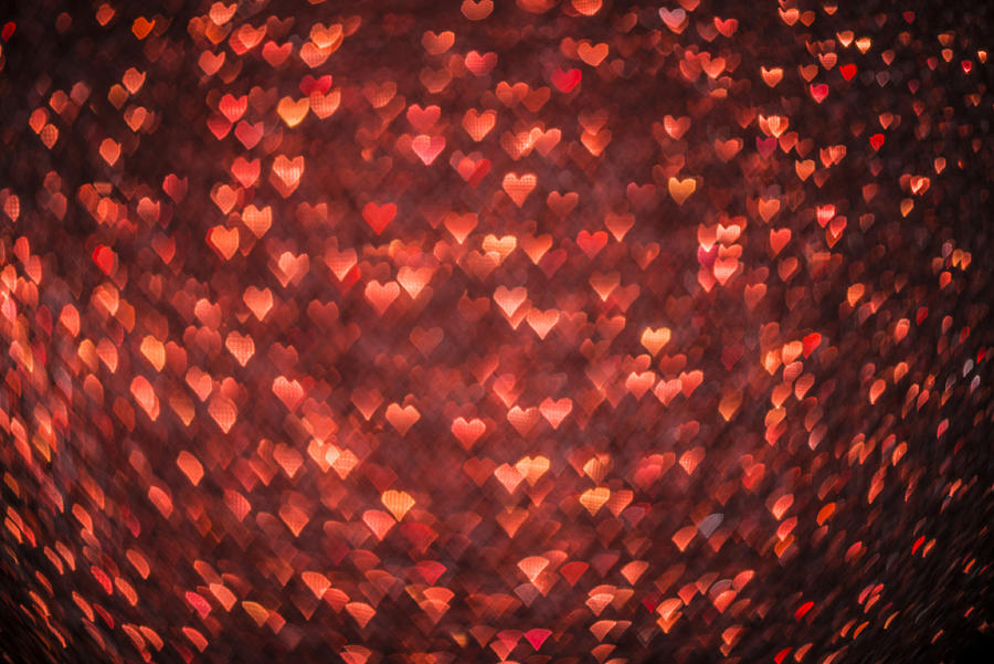 Abstract heart shaped bokeh christmas light red defocussed background Photograph by Ilbusca