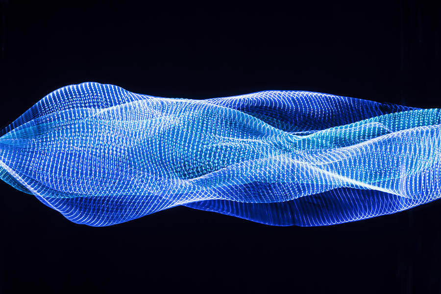 Abstract pattern of blue lights Photograph by PM Images