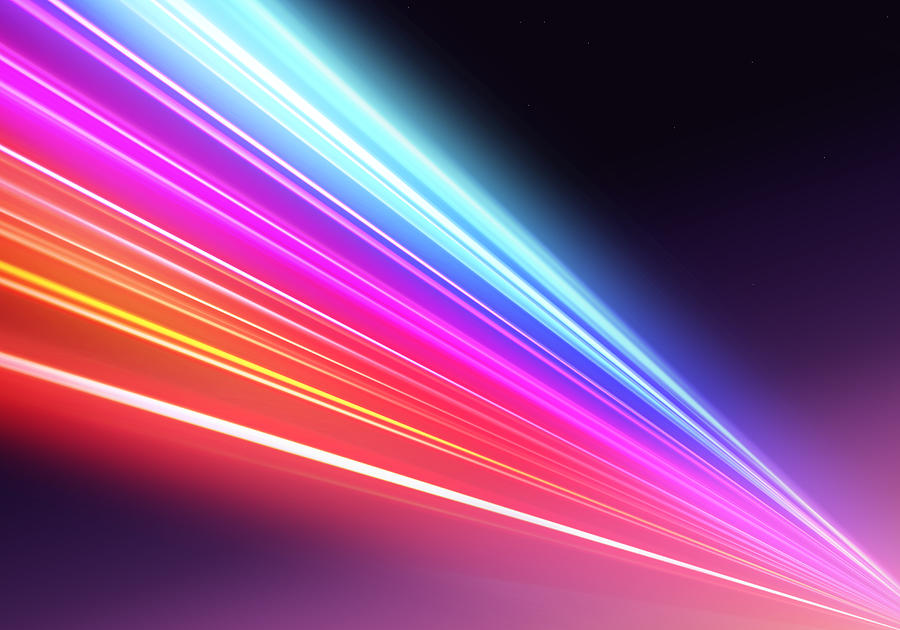 Abstract picture of colorful light trails crossing twilight sky with fast motion. Photograph by Artur Debat