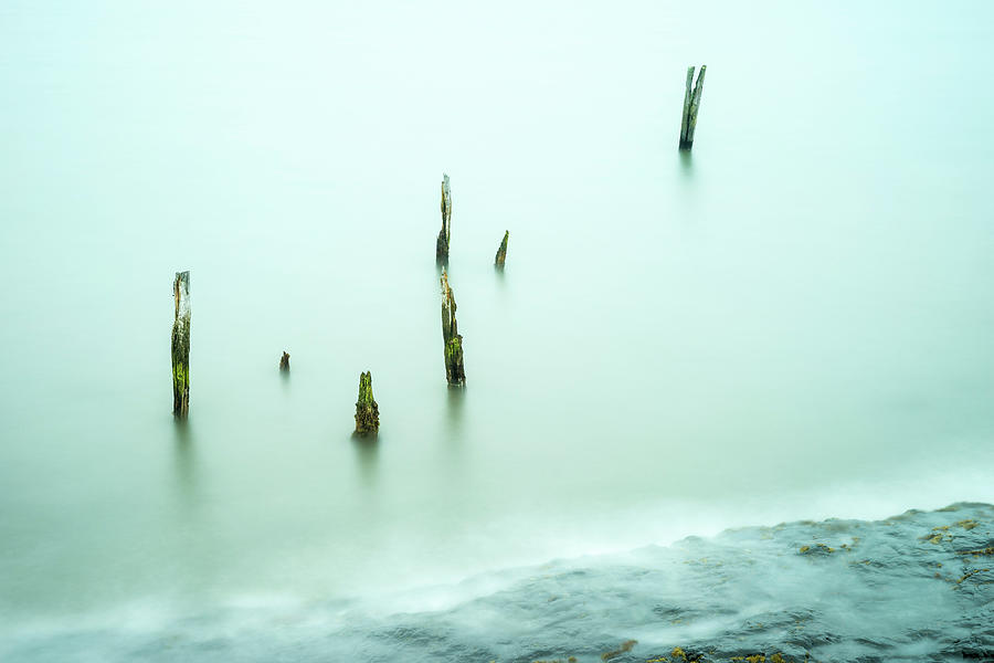 Abstract posts at high tide - Lindisfarne Photograph by John Paul Cullen