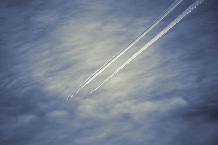 Abstract shot of two airplanes followed by jet trails flying through a cloudy sky - duotone Photograph by Ulrich Kunst And Bettina Scheidulin