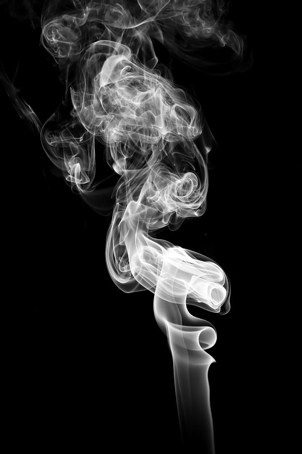 Abstract white smoke on black background. Photograph by Warongdech