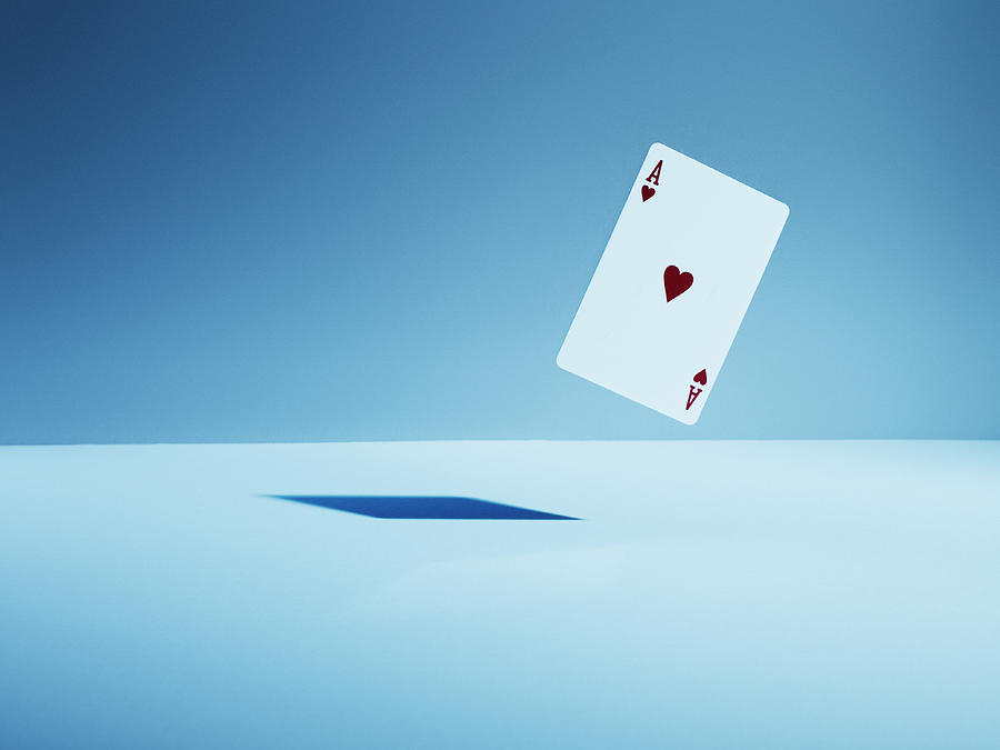Ace of hearts playing card in mid-air Photograph by Martin Barraud