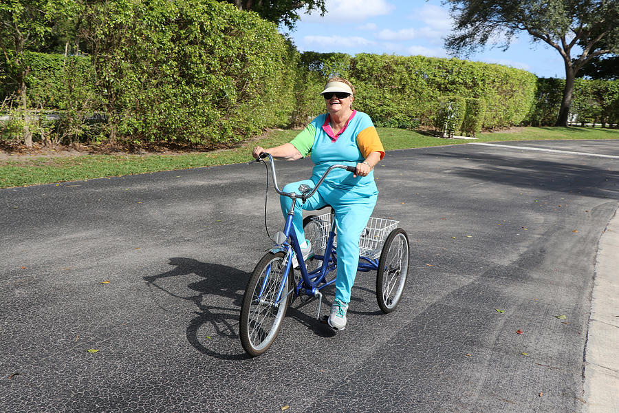 Active senior adult riding a three-wheeled bike Photograph by Image by Marie LaFauci