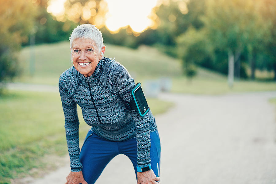 Active senior woman exercising outdoors Photograph by Pixelfit