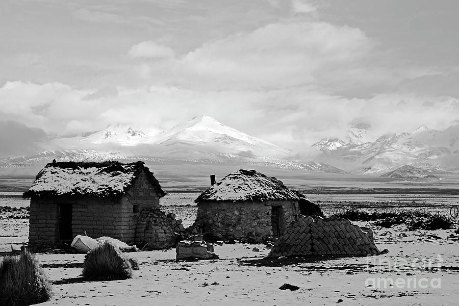 Adobe houses in the snow in monochrome Bolivia Photograph by James Brunker