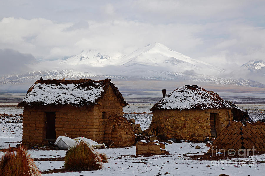 Adobe houses in the snow Sajama National Park Bolivia Photograph by James Brunker