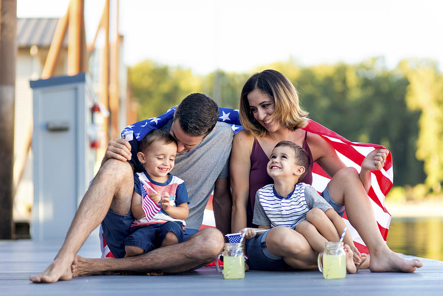 Adorable family of four together on Independence Day Photograph by FatCamera