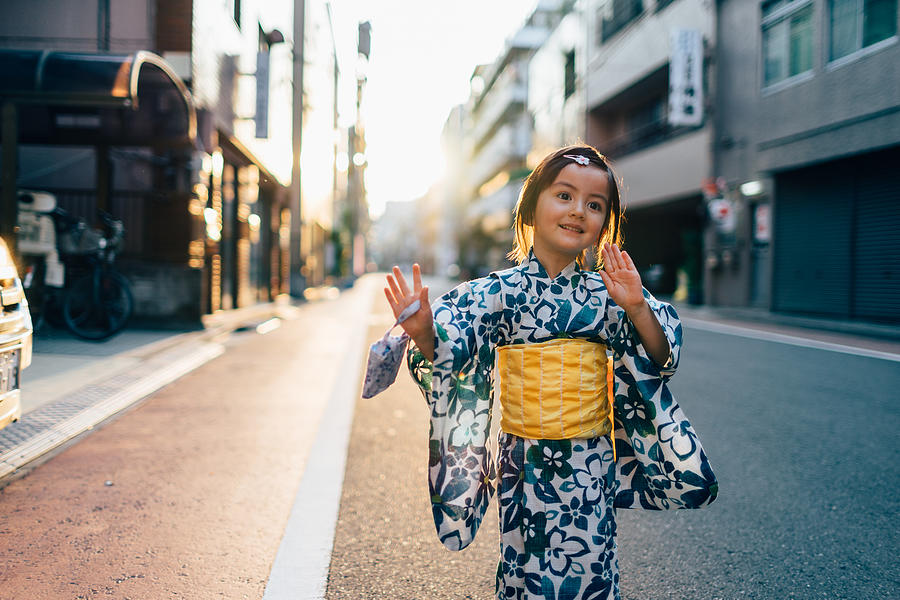 Adorable mixed race little girl in yukata dancing in the street, Tokyo Photograph by Ippei Naoi