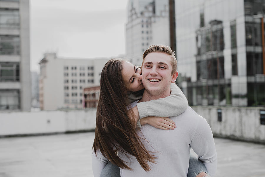 Adorable Young Couple Kissing on Cheek Photograph by Bernine
