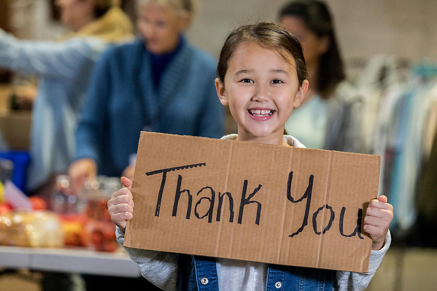 Adorable young food bank volunteer holds Thank You sign Photograph by SDI Productions
