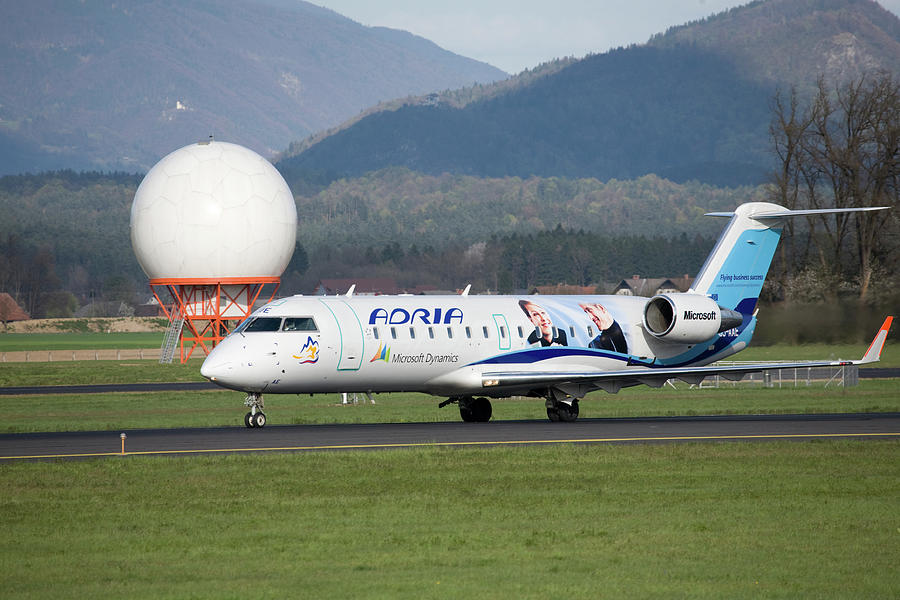 Adria aircraft with Microsoft advertising on the side at Ljublja Photograph by Ian Middleton