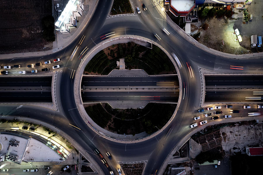 Aerial drone top view of a modern motorway junction roundabout with cars moving. Transportation infrastructure, Photograph by Michalakis Ppalis