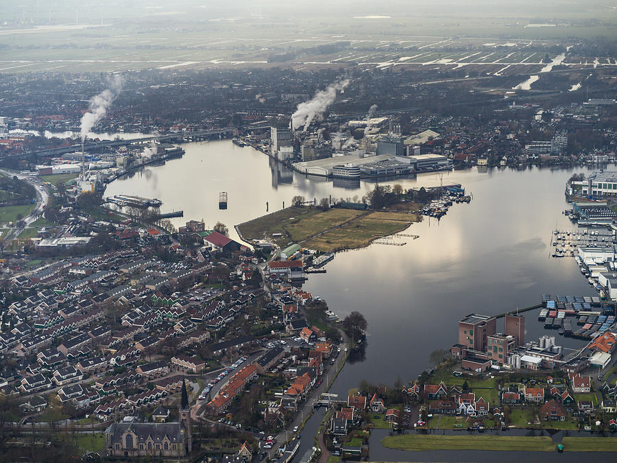 Aerial flying over outer Amsterdam, factories Photograph by Nisian Hughes