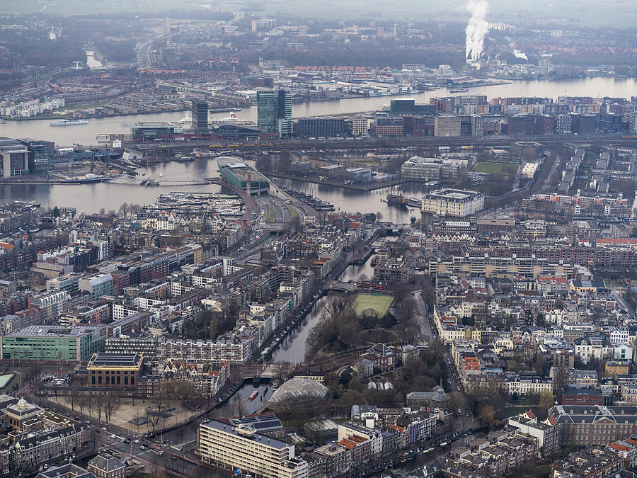 Aerial of Amsterdam city center with rooftops and canals Photograph by Nisian Hughes