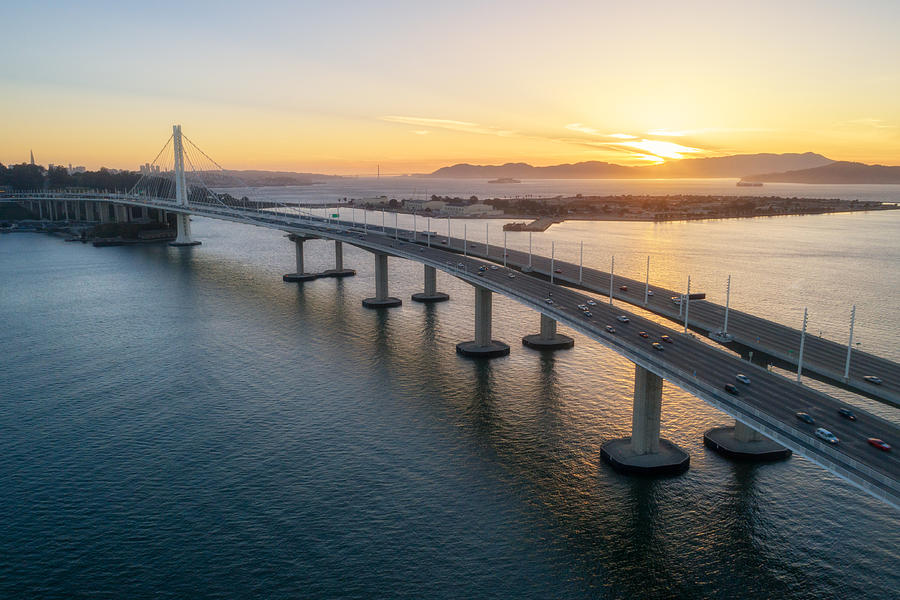 Aerial over traffic Bay Bridge at sunset, San Francisco, USA Photograph by Jonathan Clark