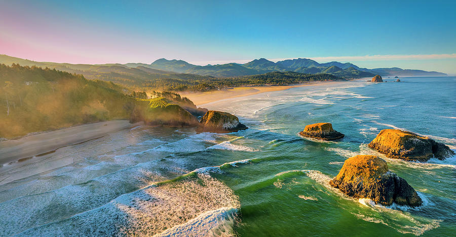 Aerial 2 photo pano hovering over the ocean at golden hour of 3 Bird Rocks, Ecola Park, Cannon Beach Photograph by Chris Anson