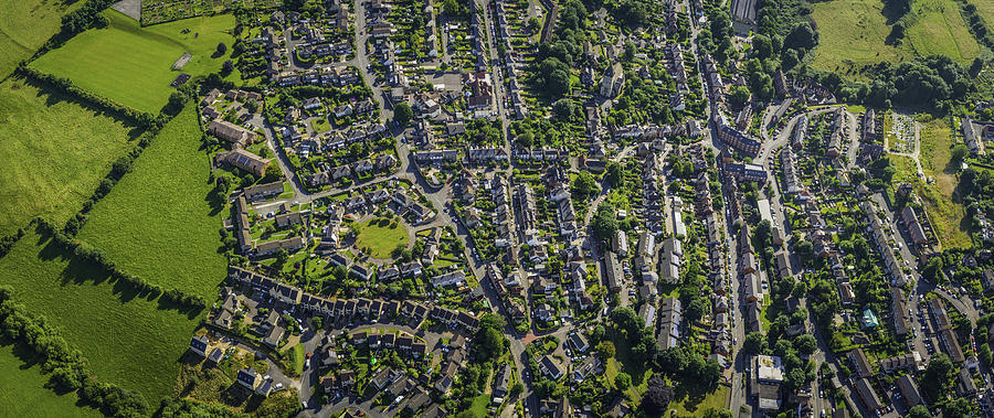 Aerial panorama over suburban homes gardens streets housing green fields Photograph by fotoVoyager