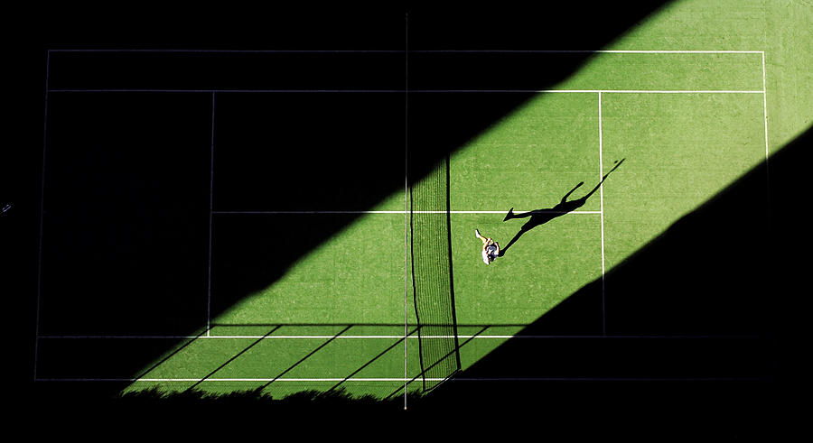 Aerial shot of tennis match from above with players shadow Photograph by Kolbz